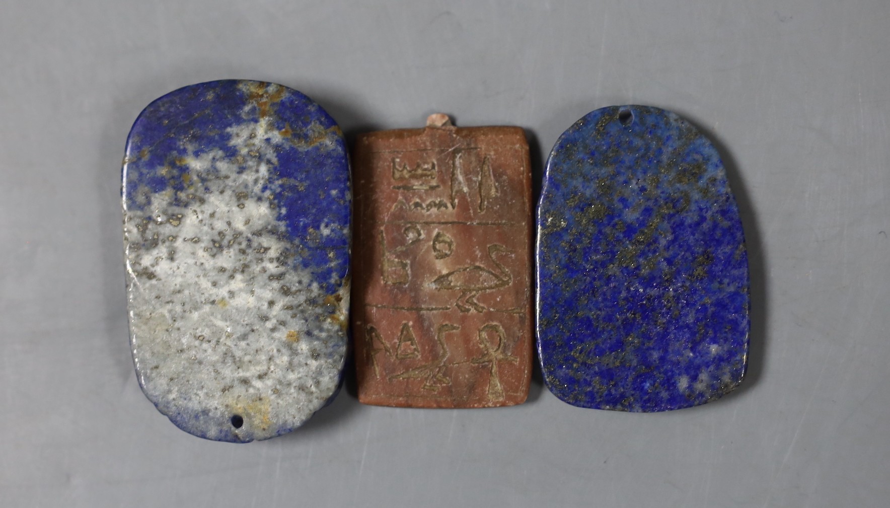 Two lapis lazuli pendants and an Egyptian carving